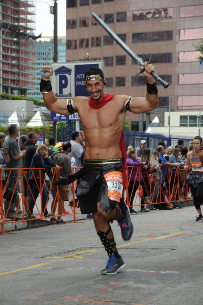 John running the half-marathon dressed as a spartan and self-confident